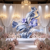 Installation de fleurs géantes en papier iris bleu avec ruban fluide pour toile de fond de mariage, vitrine de centre commercial et décoration de scène événementielle