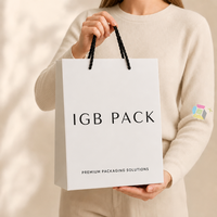 Sac cadeau en papier d'art de luxe sur mesure avec nœud en ruban et impression de logo pour l'emballage de boutiques