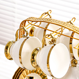 ชุดน้ำชาเซรามิกสีขาวทองหรูหรา พร้อมถ้วยกาแฟและจานรอง ชุดกาน้ำชาพอร์ซเลนพร้อมที่วางโลหะ - Product Image 5