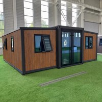 Maison préfabriquée modulaire extensible moderne à cadre noir, mini-maison de luxe, cabane de séjour en conteneur pour maison d'hôtes