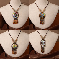 Collier vintage ethnique en alliage, longue chaîne bohème pour pull, pendentif polyvalent unisexe avec breloques à pompons, accessoires