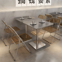 Ensemble de salle à manger de style industriel avec table carrée en acier inoxydable embossé + chaise pliante transparente ambrée