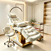 Table de massage électrique au design moderne et créatif, en cuir synthétique capitonné, avec base dorée et 4 moteurs, pour salon de beauté et esthétique