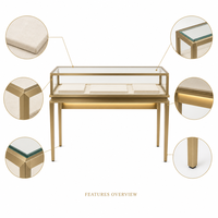 Vitrine à bijoux sur pied haut de gamme couleur or champagne, style musée moderne avec éclairage LED et dessus en verre verrouillable