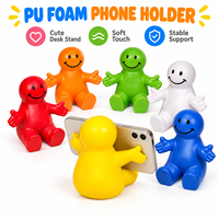 Support de téléphone portable de bureau 2-en-1 Happy Dude à bras ouverts en mousse PU anti-stress pour l'éducation