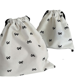 White Cotton Drawstring Gift Bag <b>with</b> Black <b>Bow</b> Print for Jewelry and Cosmetic Packaging - Product Image 1