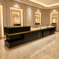 Comptoir de présentation de bijoux noir et or personnalisé avec éclairage LED et verre verrouillable pour magasin de détail