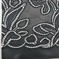 Tissu en cuir PU perforé brodé à découpe laser noire à motif floral abstrait pour manteau et textile de maison