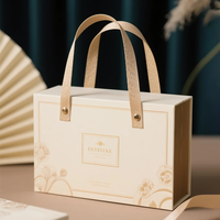 Boîte cadeau pliante en carton rose personnalisée avec poignée en cuir pour l'emballage de vernis à ongles et de crème pour le visage, boîtes rigides