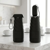 Nouvelle mini-ombrelle manuelle transfrontalière avec poignée rétractable, en plastique noir, protection solaire et pluie, double usage, pratique, pliable à 50%