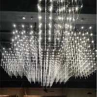 Grand lustre LED ANNO avec design étoilé multi-couches, luminaire suspendu en cascade personnalisé pour atrium à plafond haut