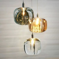 Lustre design créatif de luxe moderne à tête unique ovale et lampes suspendues en verre pour escaliers