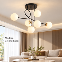 Lustre moderne noir à 6 globes en verre avec accents dorés et bras en forme de branche pour chambre, salle à manger, salon, hôtel