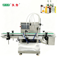 Machine de remplissage automatique de liquides à 4 têtes pour bouteilles d'huile d'olive, bouteilles cosmétiques et bouteilles d'huiles essentielles.
