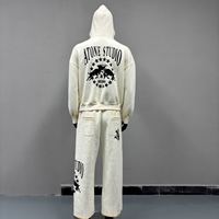 Ensemble de survêtement 2 pièces personnalisé à bords effilochés, comprenant un sweat à capuche court zippé et un pantalon de survêtement large, avec imprimé graphique gothique, style streetwear décontracté