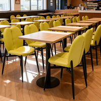 Chaise de salle à manger moderne en cuir PU jaune avec structure en acier durable et pieds en métal noir pour restaurant, café, bar