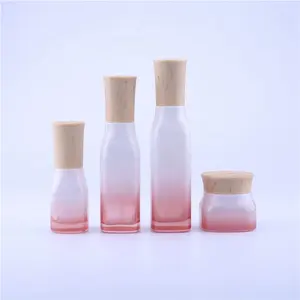 新的化妆品子装瓶，樱花红木纹盖香水和奶油按压玻璃包装瓶带喷雾器泵