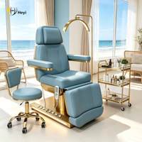 Table de massage électrique réglable pour salon de beauté avec base en métal pour usage hôtelier