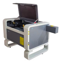 Machine de gravure laser CO2 CNC populaire 4060 6040 50W-100W pour le bois et le contreplaqué avec composants de moteur essentiels