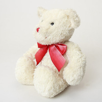 Ours en peluche doux blanc avec un joli nœud rouge en forme de ruban