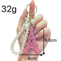 Élégant porte-clés tour Eiffel avec strass et fausse perle, accessoire tendance pour sac à main, pendentif pour femme