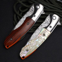 Couteau pliant portable noir imperméable d'extérieur avec acier Damas et manche en coquille blanche, personnalisable OEM pour le camping