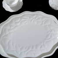 Assiette de service ovale durable de 12 pouces en porcelaine de os (Bone China) en forme de fleur pour hôtels, restaurants, banquets, OEM, vente en gros