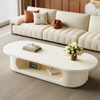 Table basse ovale blanc crème, base de rangement ouverte creuse, style minimaliste, profil bas, pour salon, table à thé