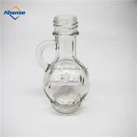 Tersedia 30Ml 1Oz Botol Kaca Logo Ukir Mini Botol Kaca Minyak Zaitun Kustom dengan Pegangan untuk Minyak