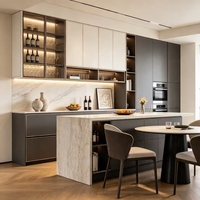 Meubles de cuisine modernes écologiques bicolores sur mesure avec finition dorée, îlot en marbre cascade sans poignées, vitrine à vin en verre OEM ODM