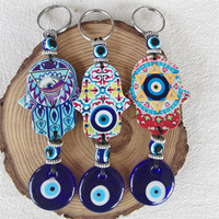 Cadeau tendance : Porte-monnaie porte-bonheur turc en alliage de zinc avec œil bleu et main de Hamsa - Pendentif pour sac/voiture/décoration intérieure