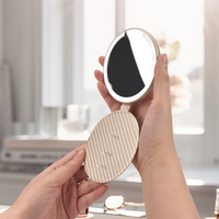 Miroir cosmétique portable circulaire pliable en métal avec cadre en cuir, lumière LED rechargeable, un seul côté, logo personnalisé