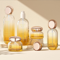 Ensemble de produits de soin de la peau haut de gamme, flacon en verre ovale 30 ml 50 ml, flacon d'essence avec tête de pompe 30 g 50 g, pot à crème avec couvercle doré