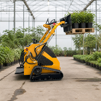 Mini-chargeuse électrique sur chenilles compacte pour l'agriculture et la construction, zéro émission, avec plateforme de travail