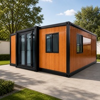 Maison modulaire en conteneur à effet bois, cabane de jardin préfabriquée avec portes à cadre noir pour projets résidentiels