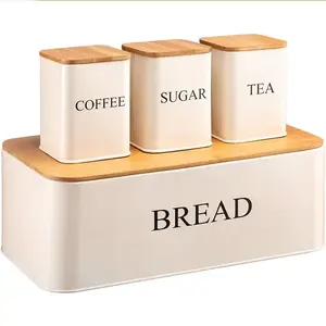أطقم علب خبز كبيرة للمطبخ من الحديد والمعدن الأبيض على طاولة ومكونة من 3 قطع من حاويات للسكري والشاي والقهوة
