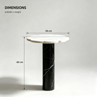 Table basse de luxe bicolore en marbre, plateau blanc festonné, base cylindrique veinée noire, design minimaliste moderne, mobile