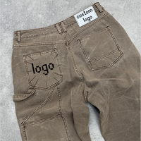 Jean en denim pour homme, taille haute, coupe large, délavé à l'acide, avec patch 3D gaufré personnalisé et rivets métalliques, style pantalon empilé