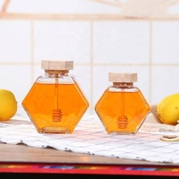 Tarro de miel único con cuchara de madera, tarro de vidrio hexagonal al por mayor para miel