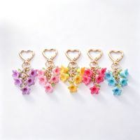Nouveau porte-clés en alliage de zinc couleur Rush, en forme de cœur, avec fleur colorée style carillon éolien, créatif et frais, à double pétale, breloque de sac