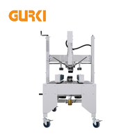 Machine de scellage automatique de cartons à ruban supérieur et inférieur GURKI pour l'emballage des boissons et des vêtements