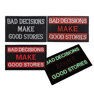 Toppa in tessuto ricamata rettangolare in tela ecologica con testo in inglese: Bad Decisions Make Good Stories - Product Image 1