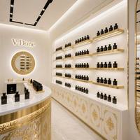 Vitrine de présentation de parfums sur mesure avec cadre doré, éclairage LED, comptoir îlot rond pour boutique de cosmétiques et de parfums