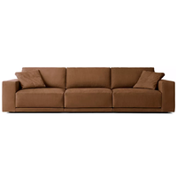 Canapé d'angle en cuir au design tendance en forme de L, avec accoudoirs larges et coussins moelleux pour salon