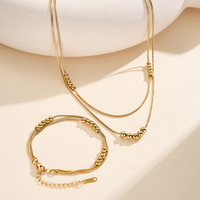 Kalung Berlapis Manik-Manik Elegan STCC04 Warna Emas Bahan Stainless Steel Desain Bola Mengambang Dua Lapis Perhiasan Cantik