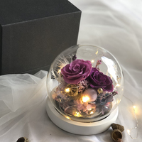 Assortiment de fleurs de roses conservées pour l'éternité en gros dans un dôme rond en verre