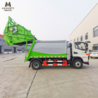 Camion compacteur de déchets HEAVSTY 7 mètres cubes 4x2 à transmission manuelle et chargement arrière, moteur et boîte de vitesses pour bacs de 120L/240L