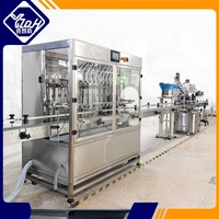 Remplisseur de bouteilles de liquide à débit automatique à 12 buses Machine de remplissage de liquide à têtes multiples Machine à sceller les boissons Eau