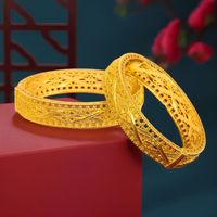 Vente en gros de bracelets creux plaqués or 24 carats, en alliage, larges, à motifs floraux en filigrane, bijoux de mode de mariage de Dubaï pour femmes