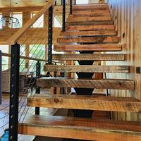 Escalier à monolier ouvert avec marches en bois massif et support structurel minimal pour intérieurs modernes